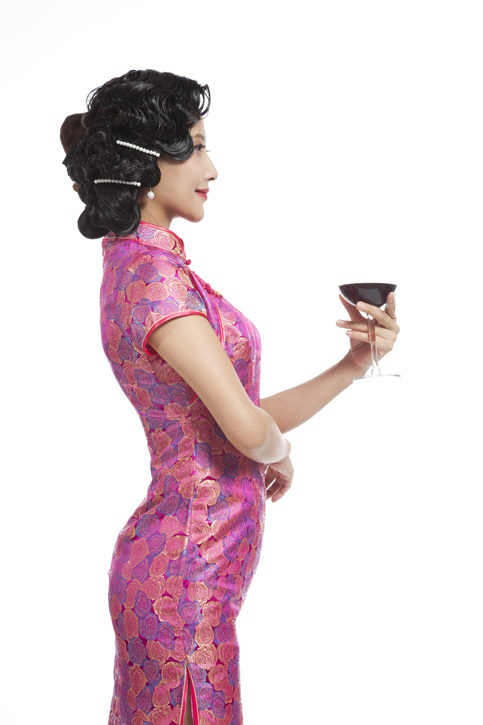 棚拍身穿旗袍的年轻女人举杯